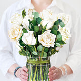 woman holding white roses bouquet