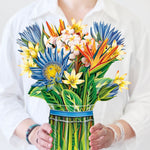 woman holding tropical bloom bouquet