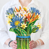 woman holding tropical bloom bouquet