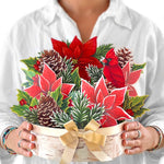 woman holding FreshCut Paper Birch Poinsettia