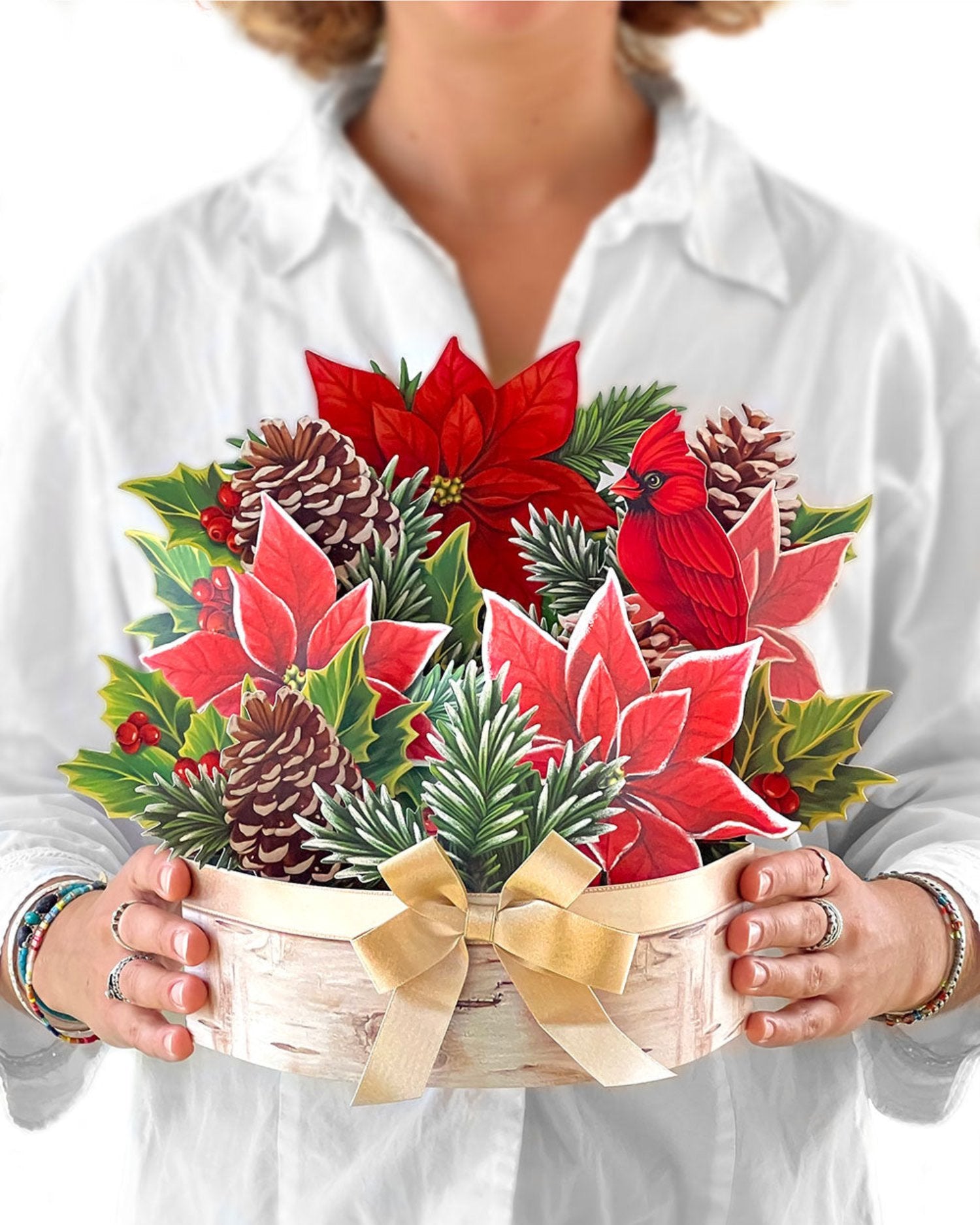 woman holding FreshCut Paper Birch Poinsettia