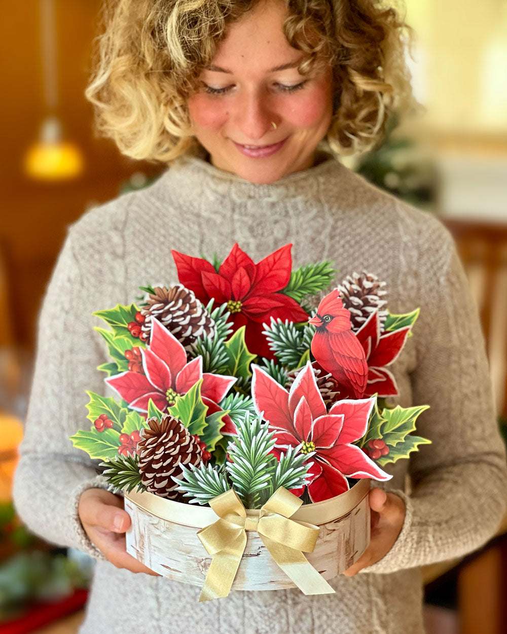 woman holding FreshCut Paper Birch Poinsettia 