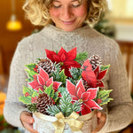 woman holding FreshCut Paper Birch Poinsettia 