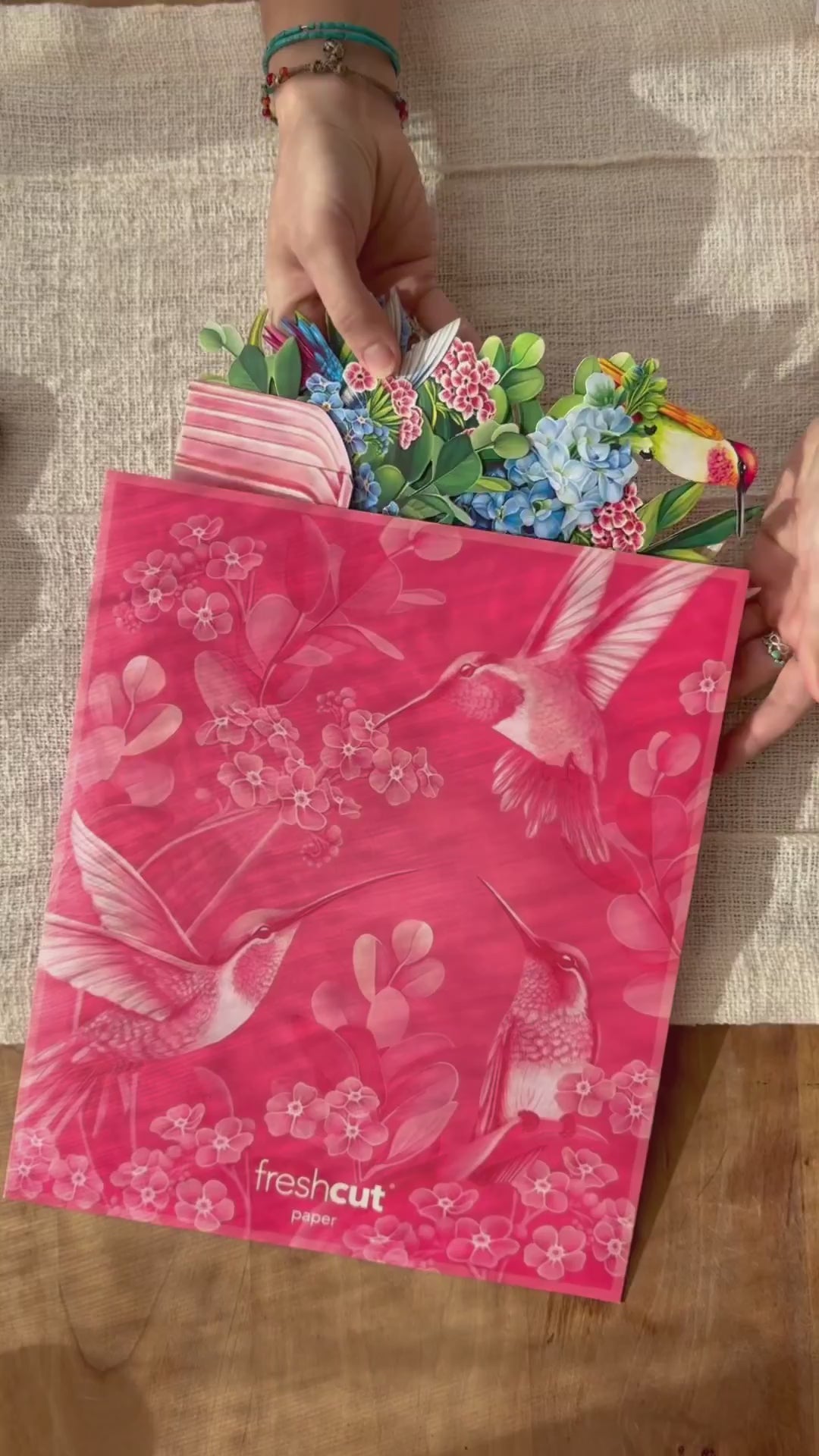 a pink envelope with birds and flowers